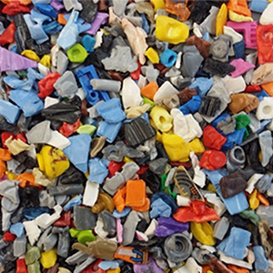 Toy recycling, colourful plastic flakes from toys, recycling from old plastic toys