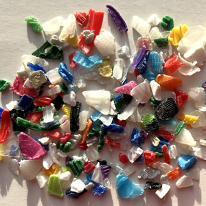 Colourful flakes from old plastic screw caps, crushed plastic bottle caps
